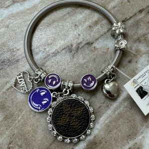 Silver bracelet with smiley face, hearts, & lookalike Louis Vuitton logo charms